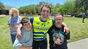 Gear Up Florida Cyclist Chase DuMond with two friends with disabilities after a Gear Up Florida Arrival.